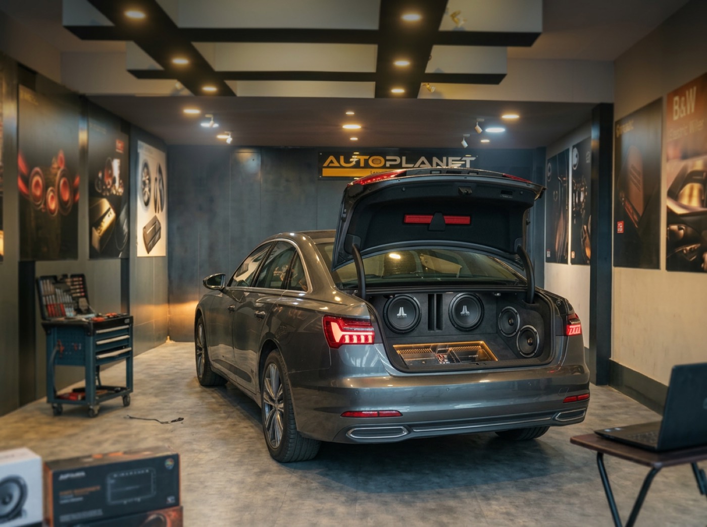 A BMW inside the Autoplanet studio in Koramangala, surrounded by car audio components laid out before installation