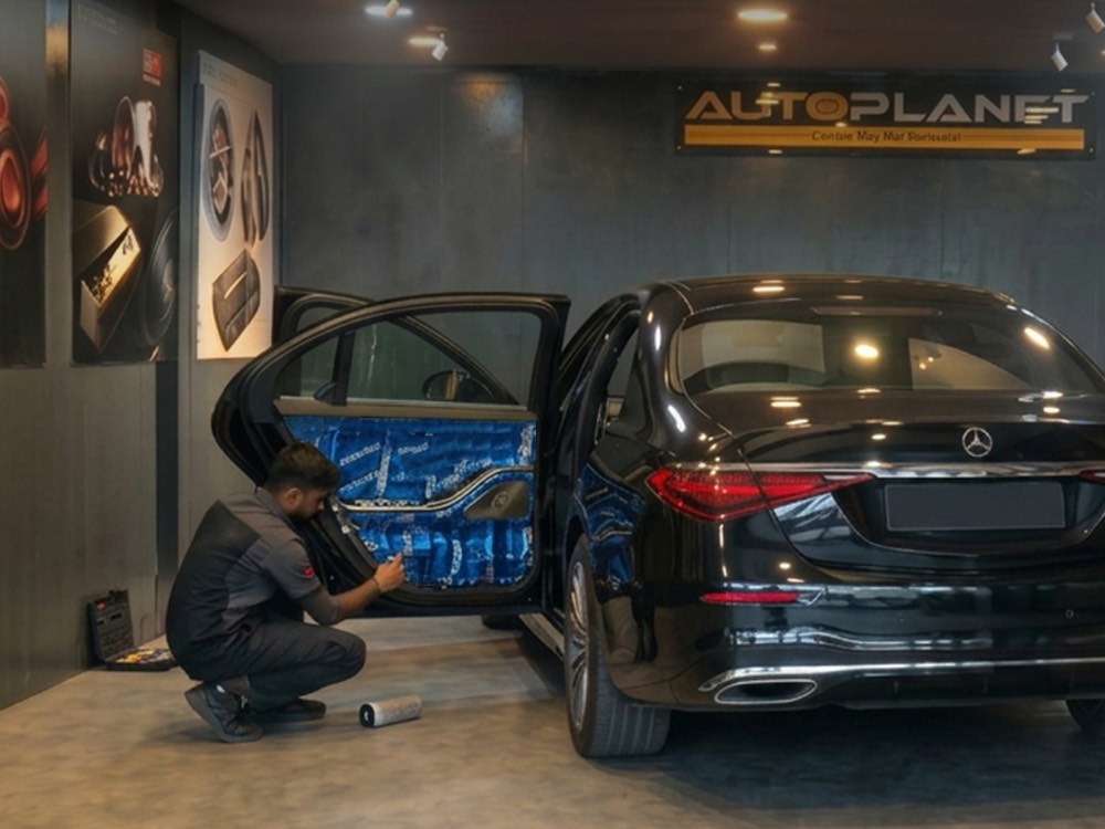 Mercedes-Benz door card removed, showing speaker mounting and sound-deadening treatment applied to the door skin